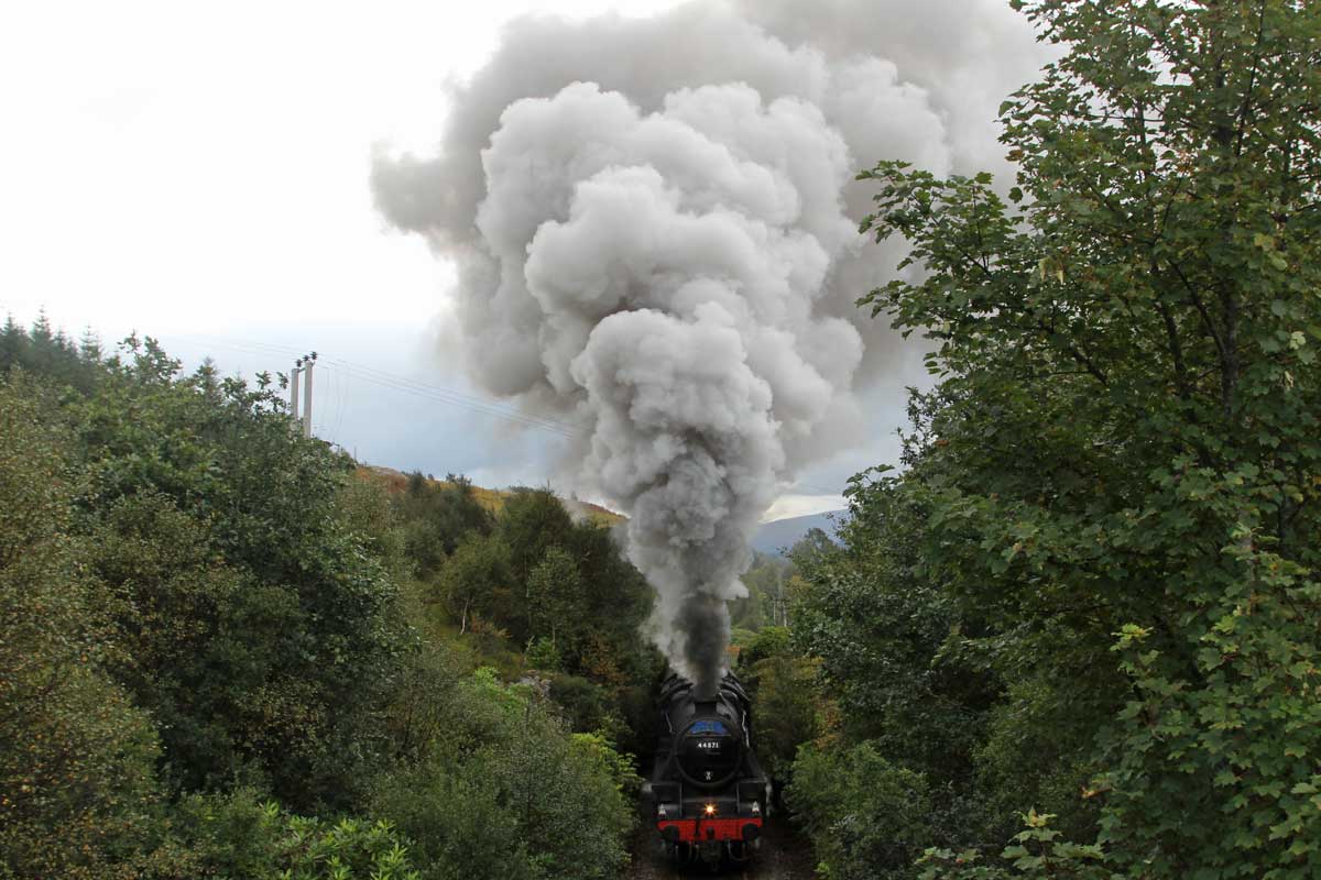 The Jacobite about to pass under the bridge at Glenfinnan
